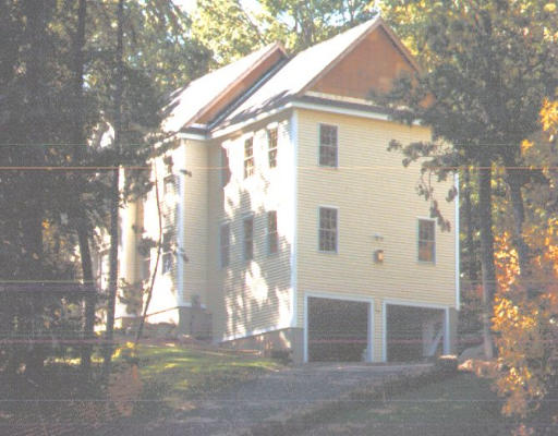 a view of a white house next to a yard with large tree