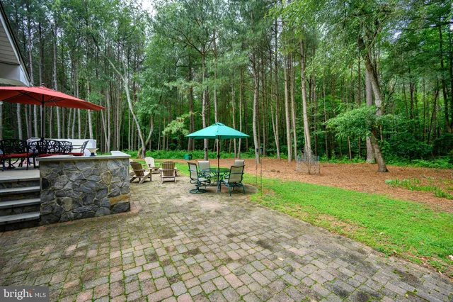a view of a house with sitting area and garden