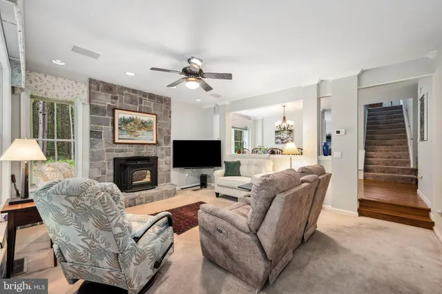 a kitchen with a refrigerator a stove top oven a sink dishwasher and white cabinets with wooden floor