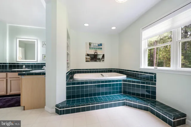 an aerial view of a residential houses with outdoor space and trees