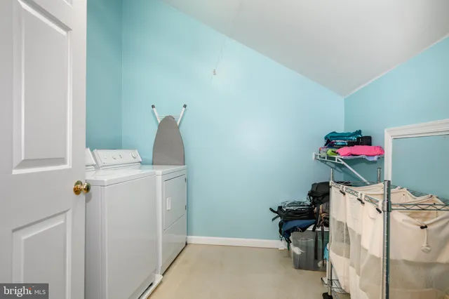 an aerial view of residential house with outdoor space and trees all around