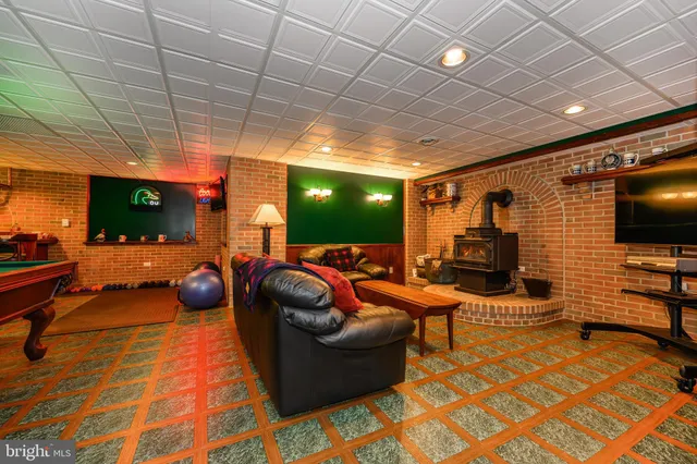 an aerial view of a house with a yard and large trees