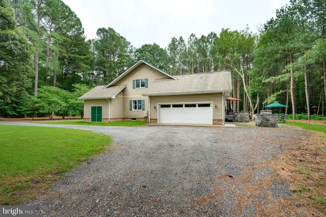 a house with lots of trees in the background
