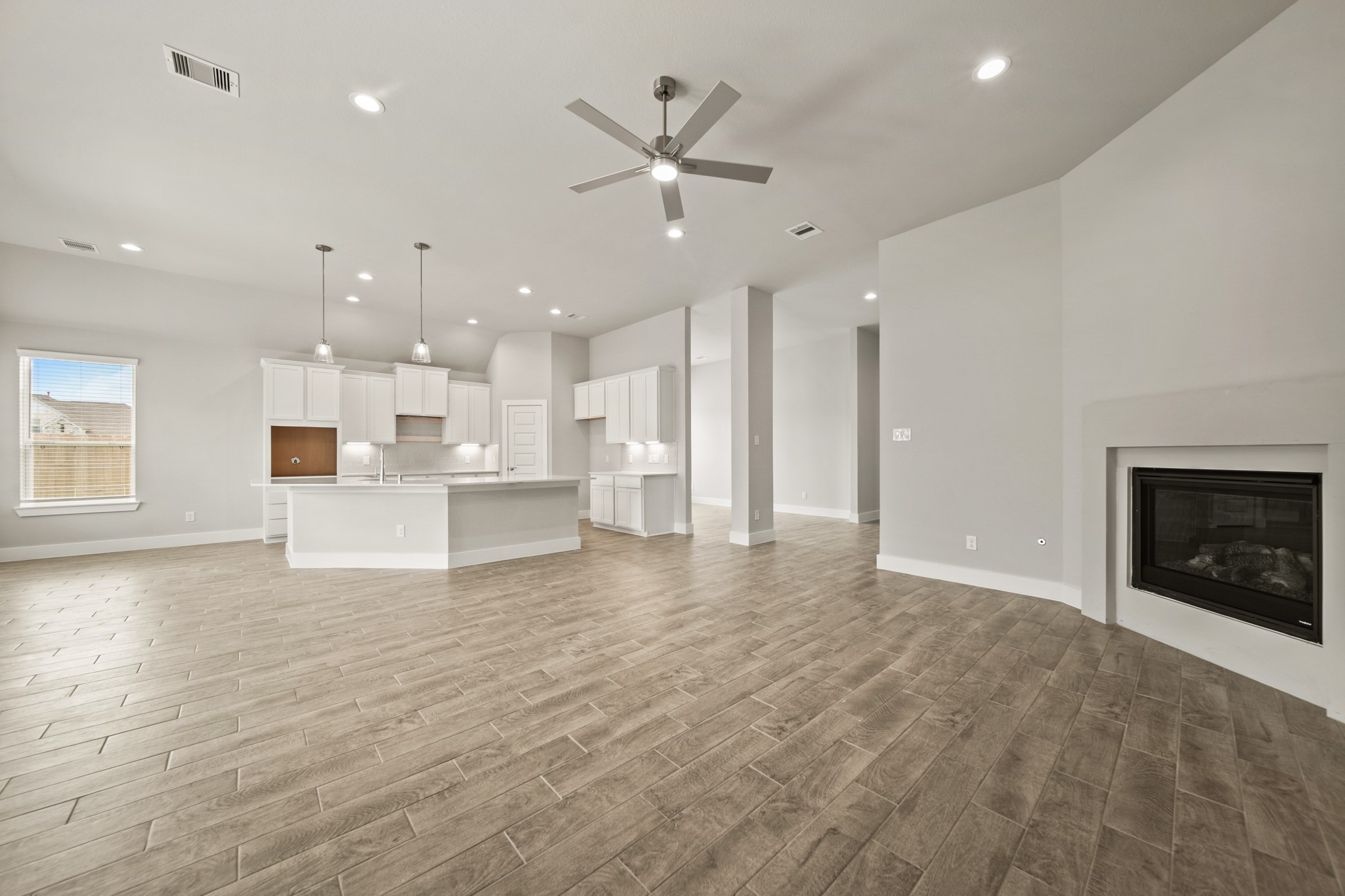 408 Inner Cove Lane Waller, TX 77484 - Photo 13 of 48 a view of an empty room with kitchen and fireplace