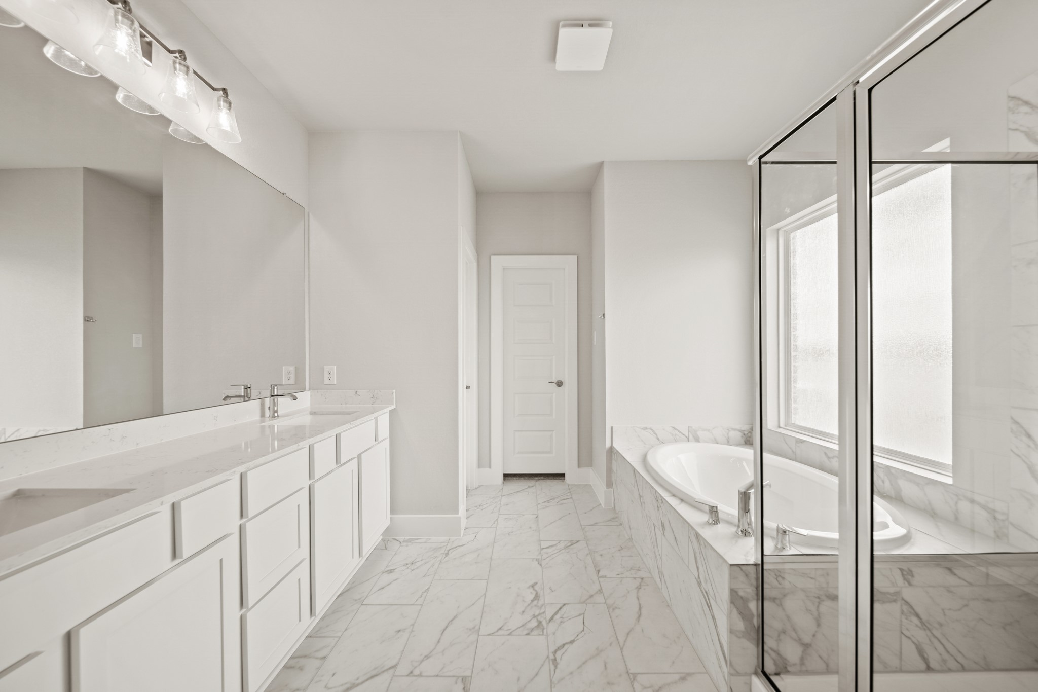 408 Inner Cove Lane Waller, TX 77484 - Photo 22 of 48 a spacious bathroom with a double vanity sink and a mirror