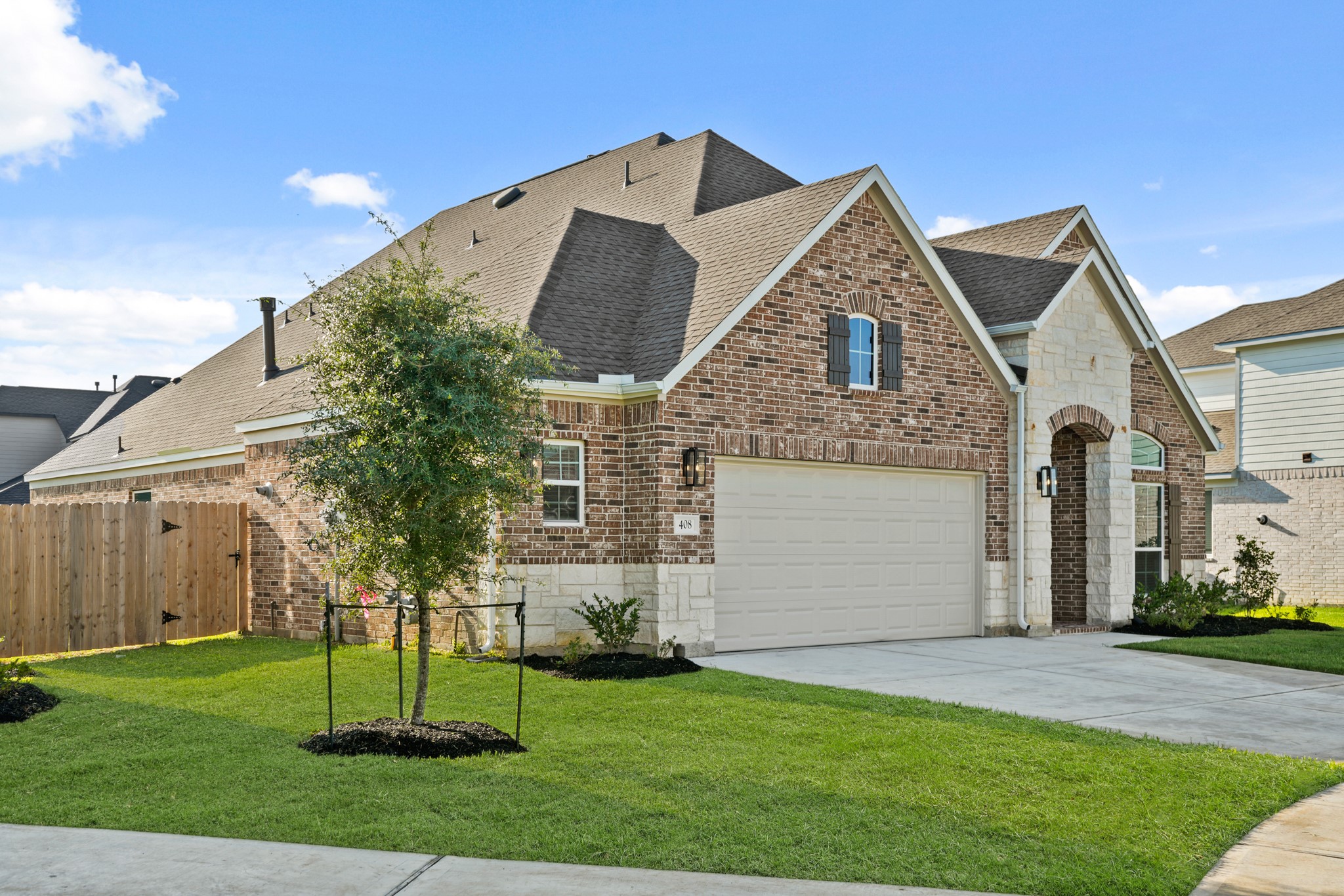 408 Inner Cove Lane Waller, TX 77484 - Photo 3 of 48 a front view of a house with a garden and plants
