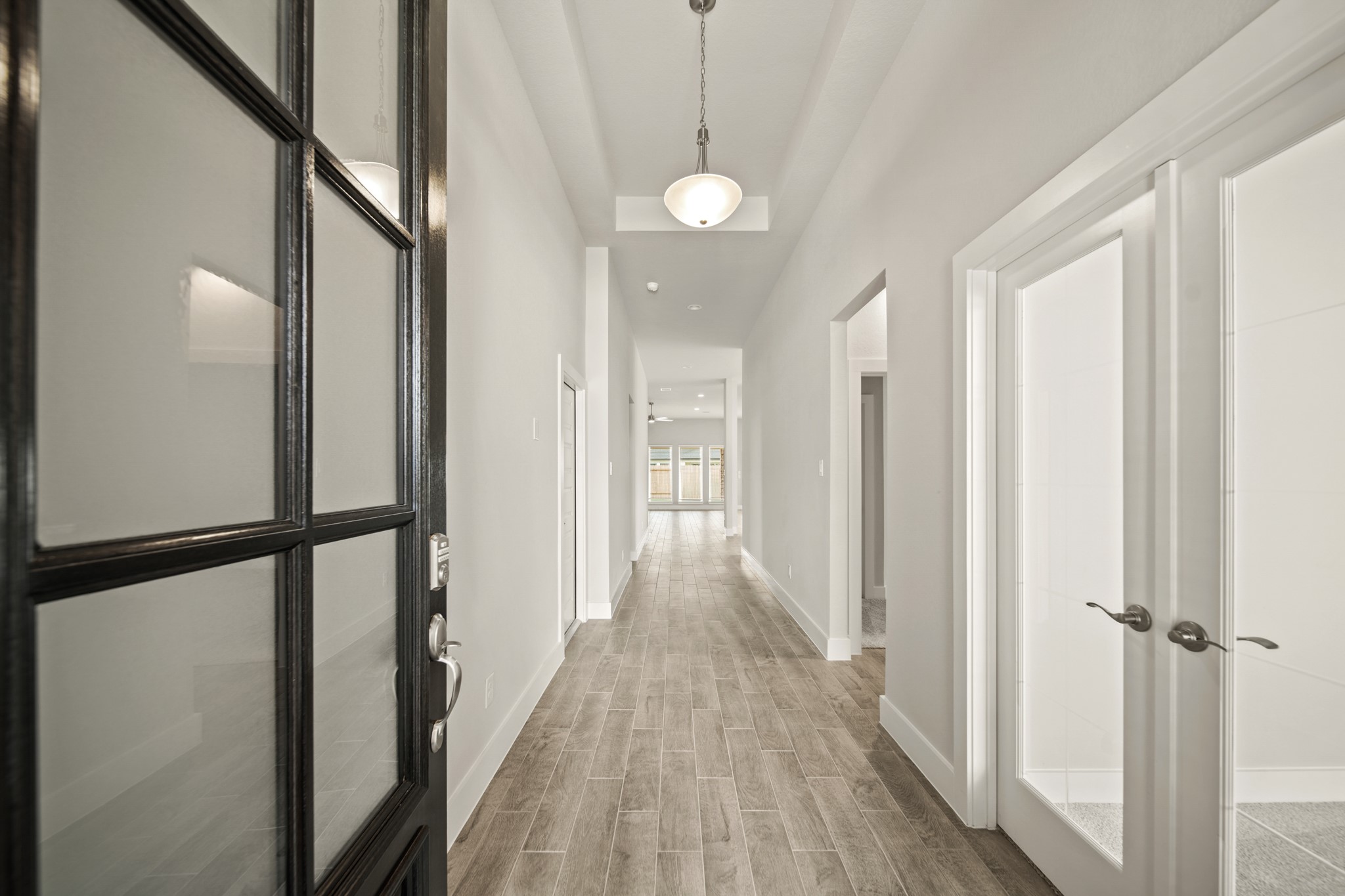 408 Inner Cove Lane Waller, TX 77484 - Photo 4 of 48 a view of a hallway with wooden floor and staircase