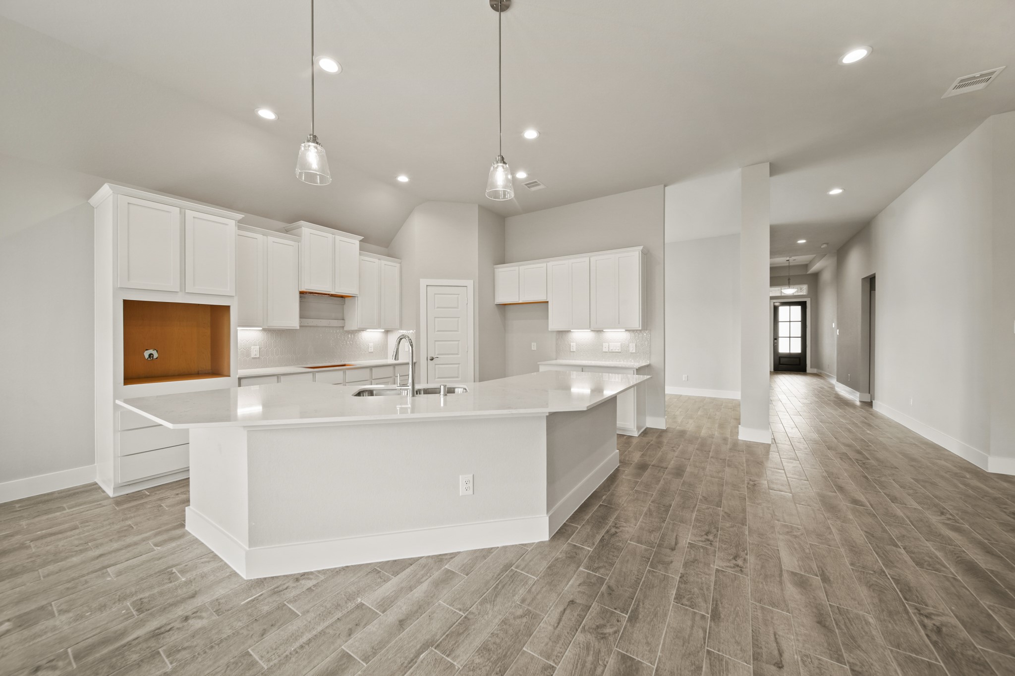408 Inner Cove Lane Waller, TX 77484 - Photo 6 of 48 a large kitchen with stainless steel appliances a large center island attached withe living room