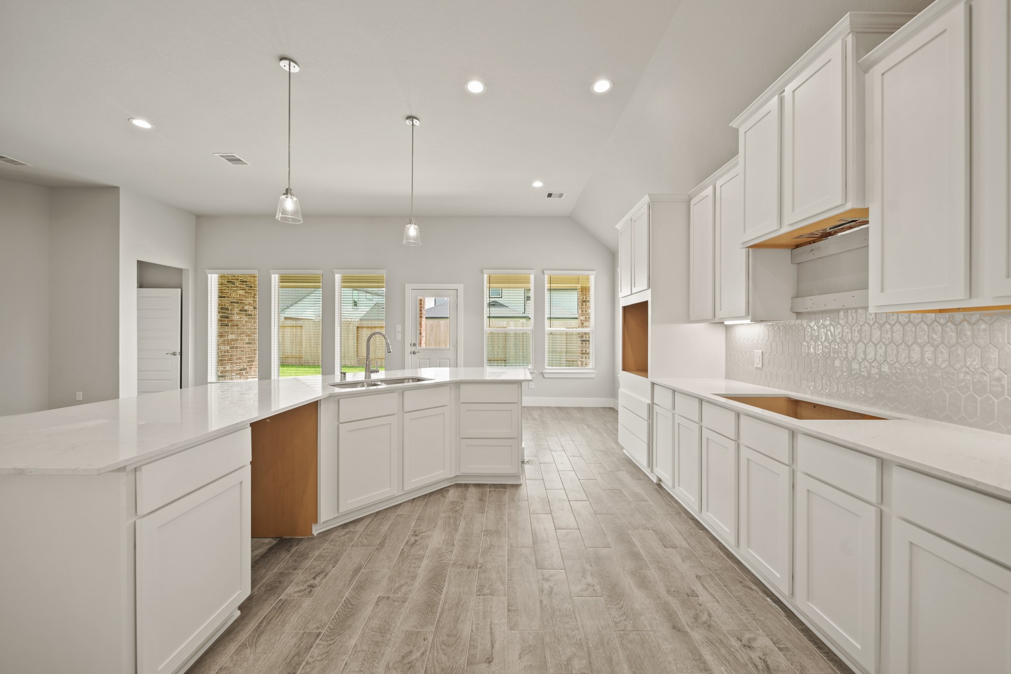 408 Inner Cove Lane Waller, TX 77484 - Photo 7 of 48 a large kitchen with stainless steel appliances kitchen island granite countertop a large counter top a sink and a stove