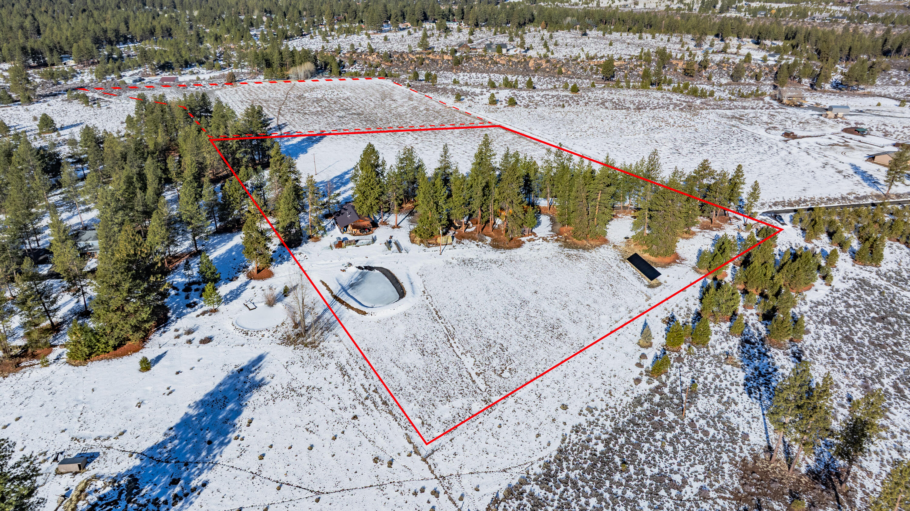 60647 Antler Road Bend, OR 97702 - Photo 44 of 44 an aerial view of a house with a yard and lake view