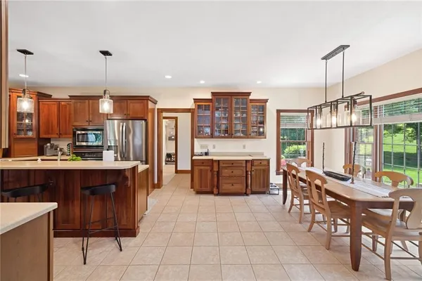 a large kitchen with a counter space a sink appliances and cabinets