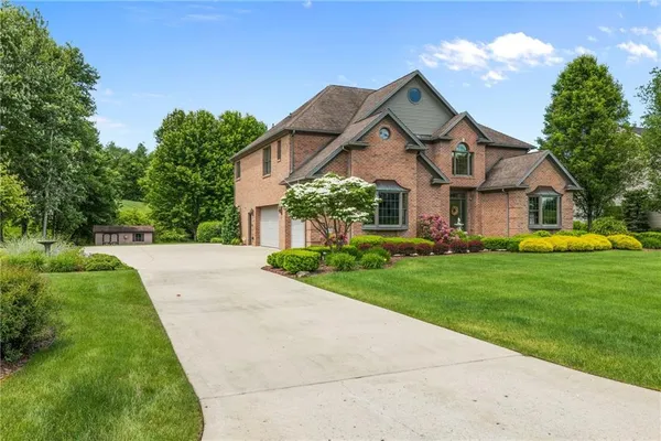 a front view of house with yard and green space