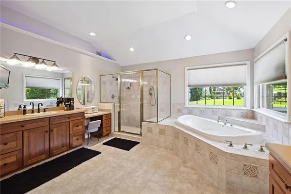 a large bathroom with a large tub shower and sink