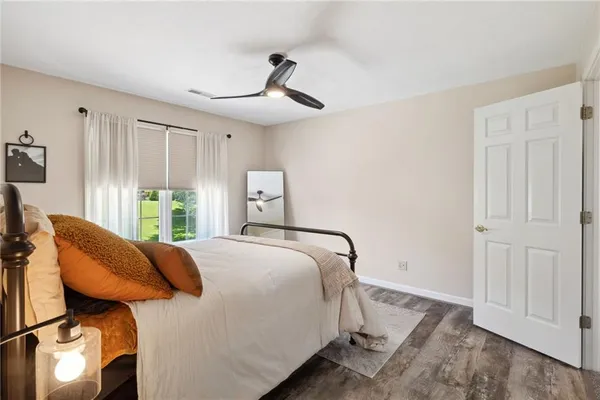 a bed sitting in a bedroom next to a window