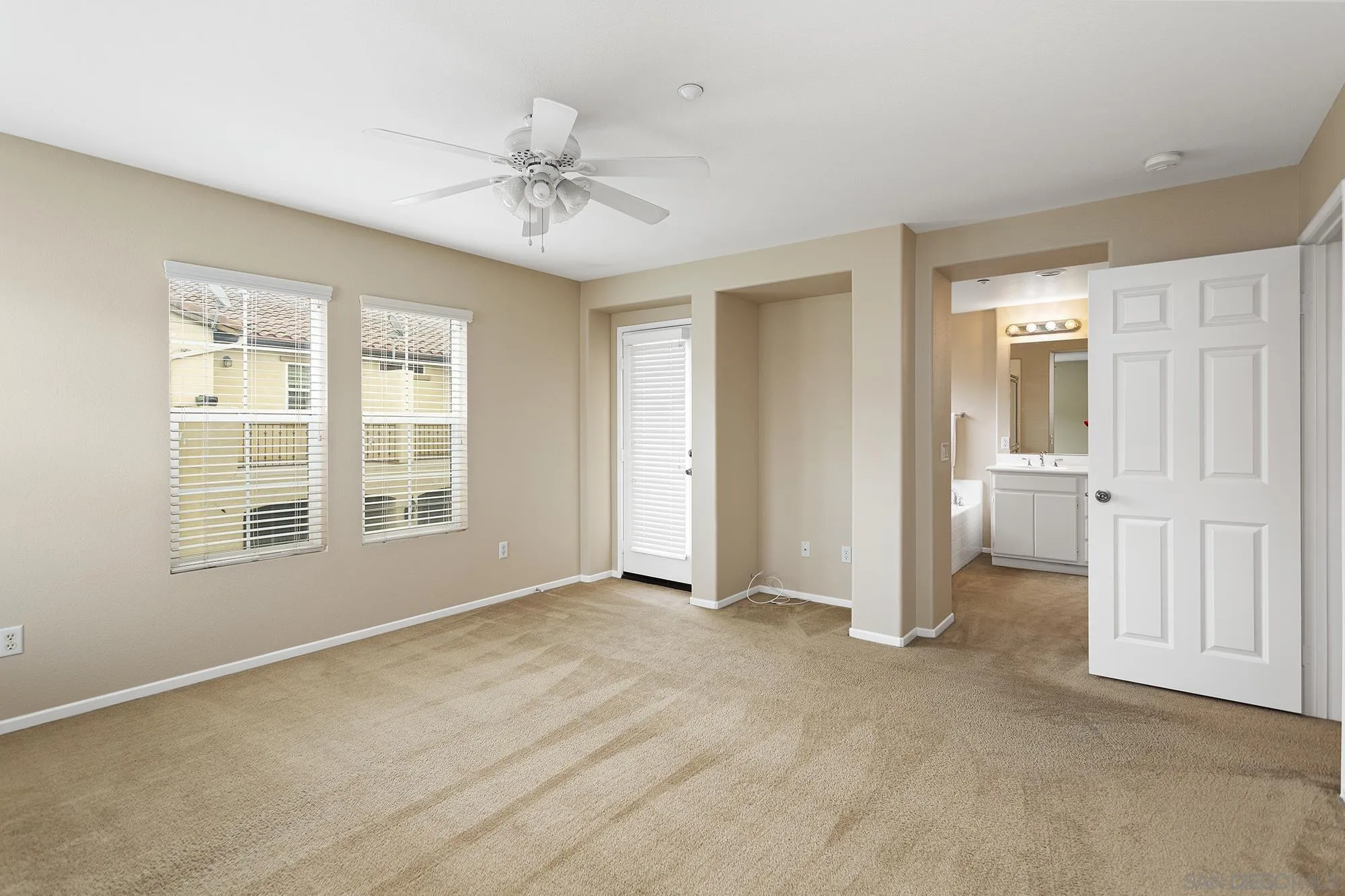 41865 Davenport Way, Unit A Murrieta, CA 92562 - Photo 13 of 26 an empty room with chandelier fan and windows