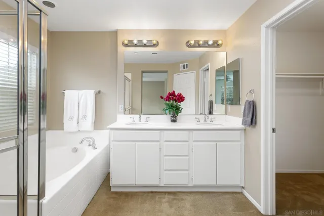 an empty room with windows and ceiling fan