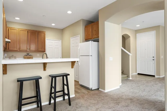 a kitchen with a sink a stove and cabinets