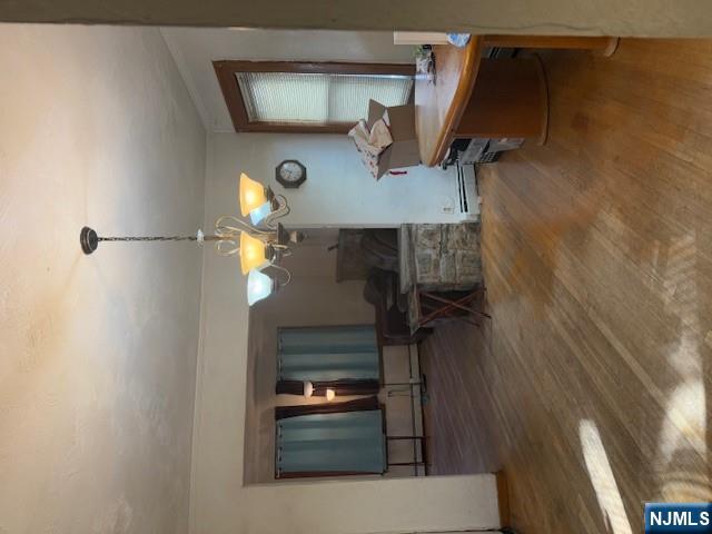 a view of a dining room with furniture a chandelier and wooden floor