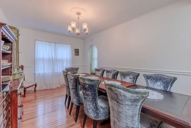 a view of a dining room with furniture and chandelier