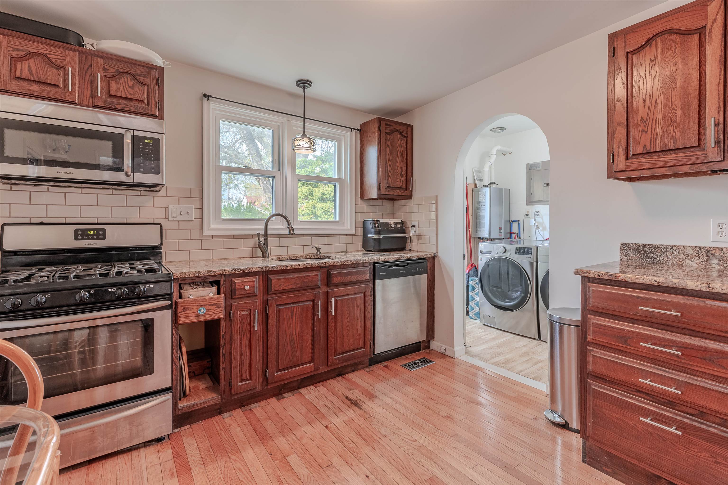 127 3rd West Cape May, NJ 08204 - Photo 14 of 38 a kitchen with stainless steel appliances wooden cabinets and a stove top oven