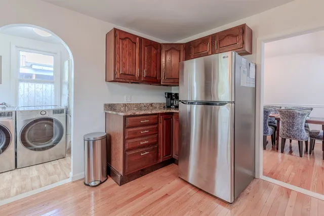 a kitchen with a refrigerator sink and cabinets