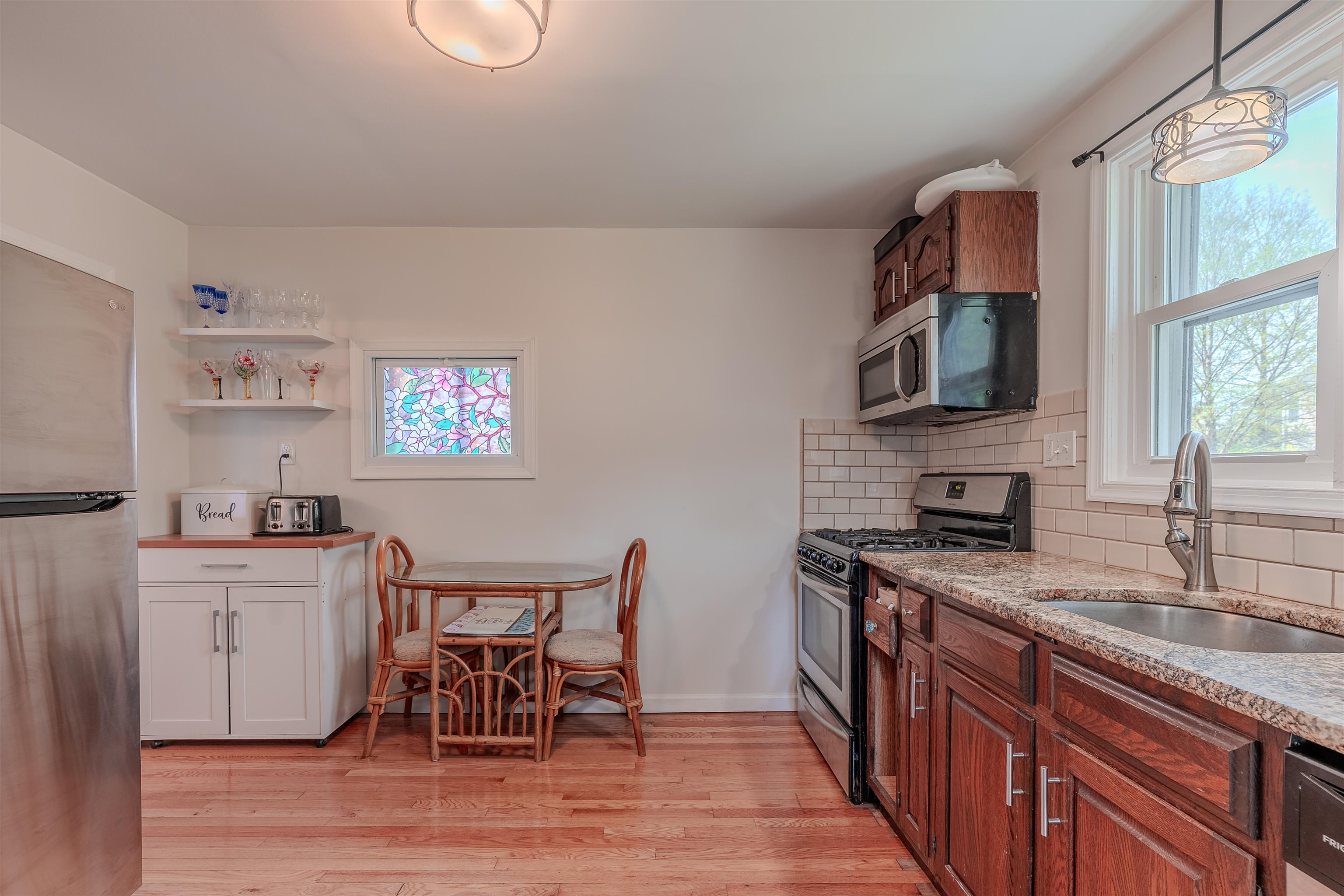 127 3rd West Cape May, NJ 08204 - Photo 16 of 38 a kitchen with stainless steel appliances granite countertop a sink stove and cabinets