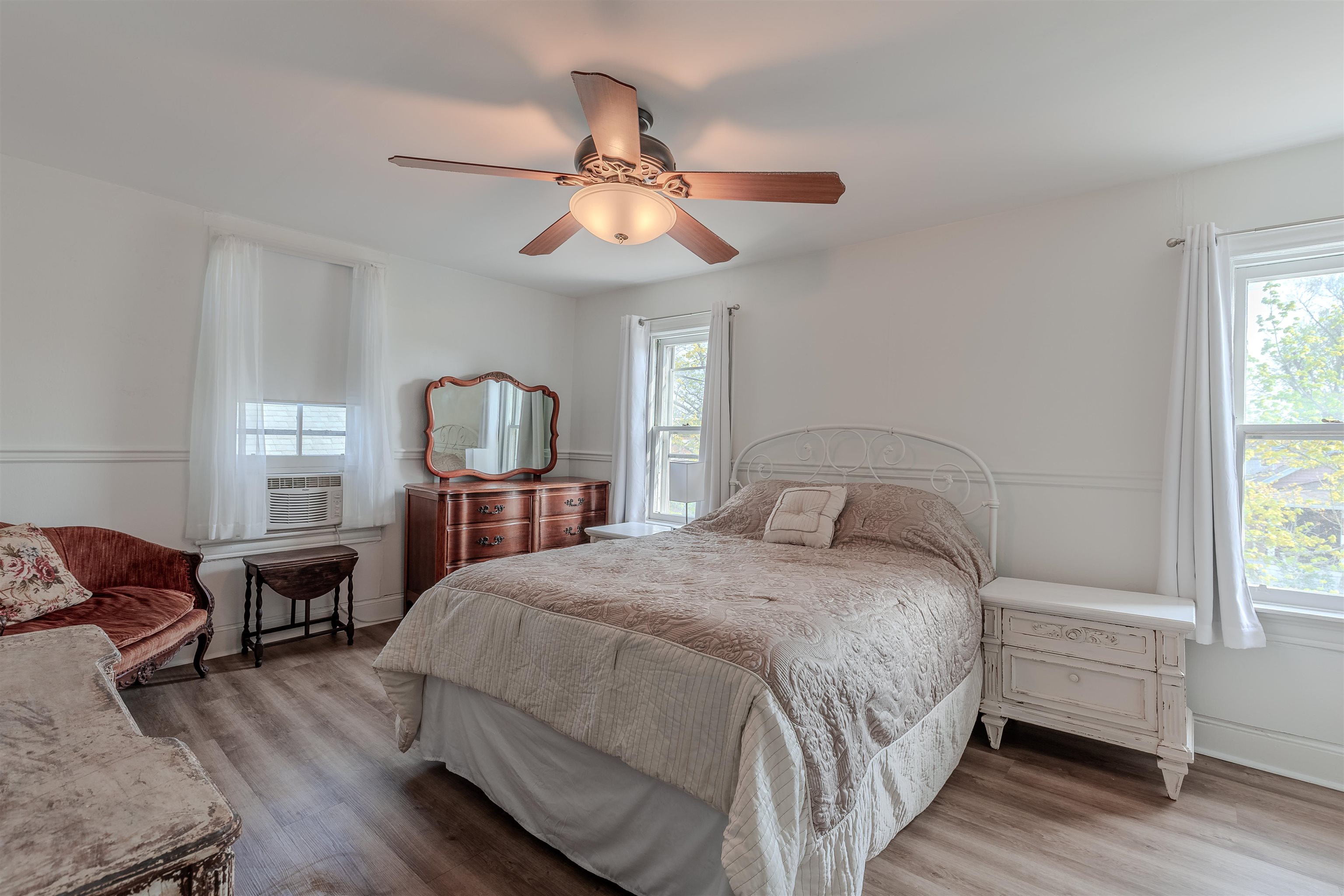 127 3rd West Cape May, NJ 08204 - Photo 21 of 38 a bedroom with a bed a chandelier and dresser