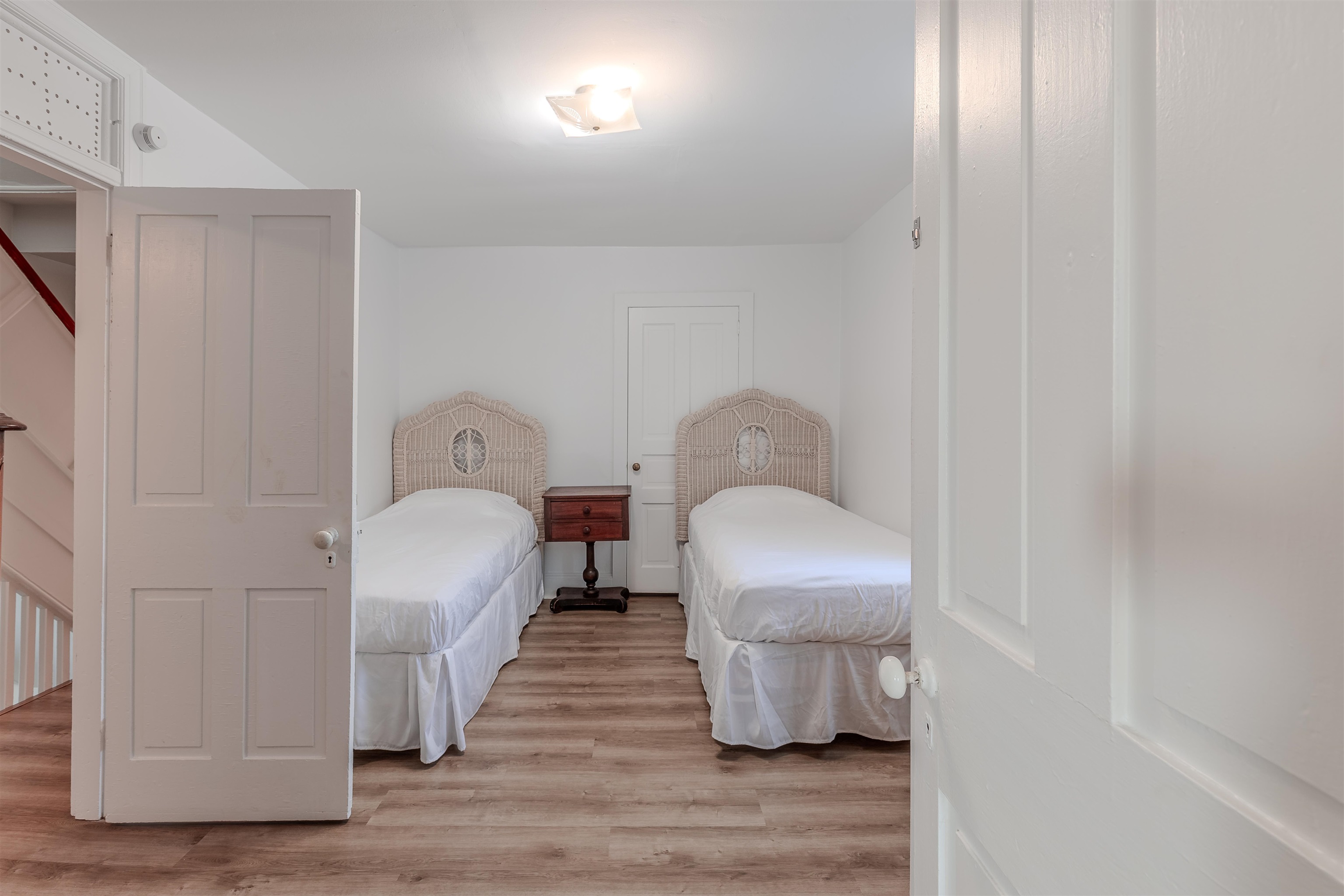 127 3rd West Cape May, NJ 08204 - Photo 24 of 38 a bedroom with a bed and wooden floor