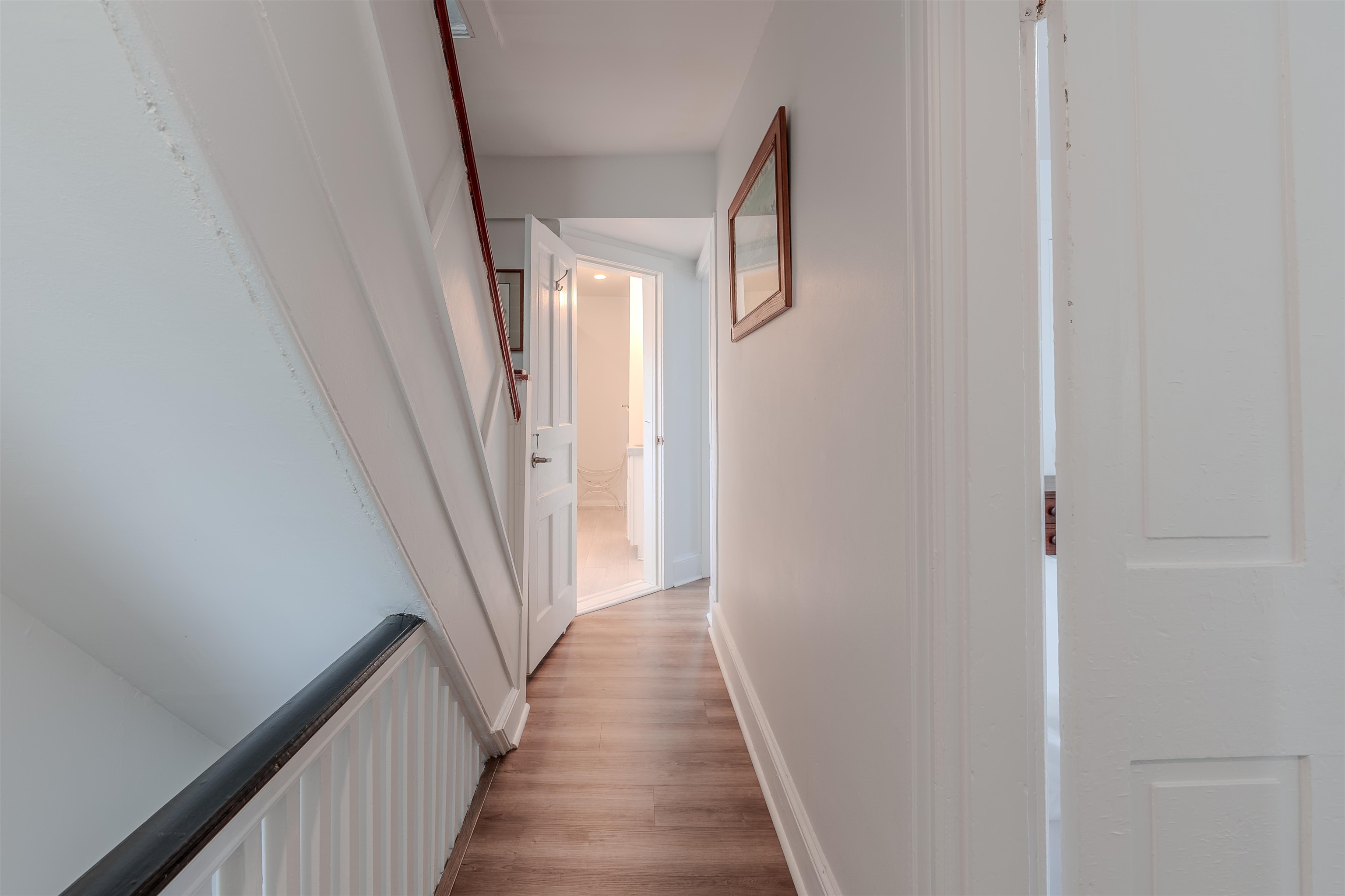 127 3rd West Cape May, NJ 08204 - Photo 26 of 38 a view of a hallway with wooden floor and staircase