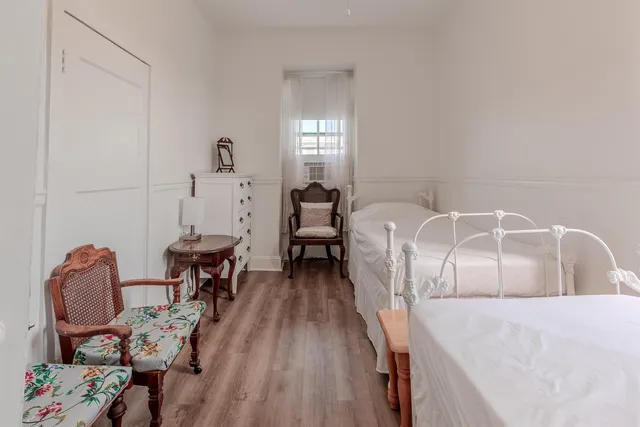 a bed room with furniture and wooden floor