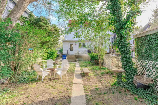 a view of backyard of house with seating space