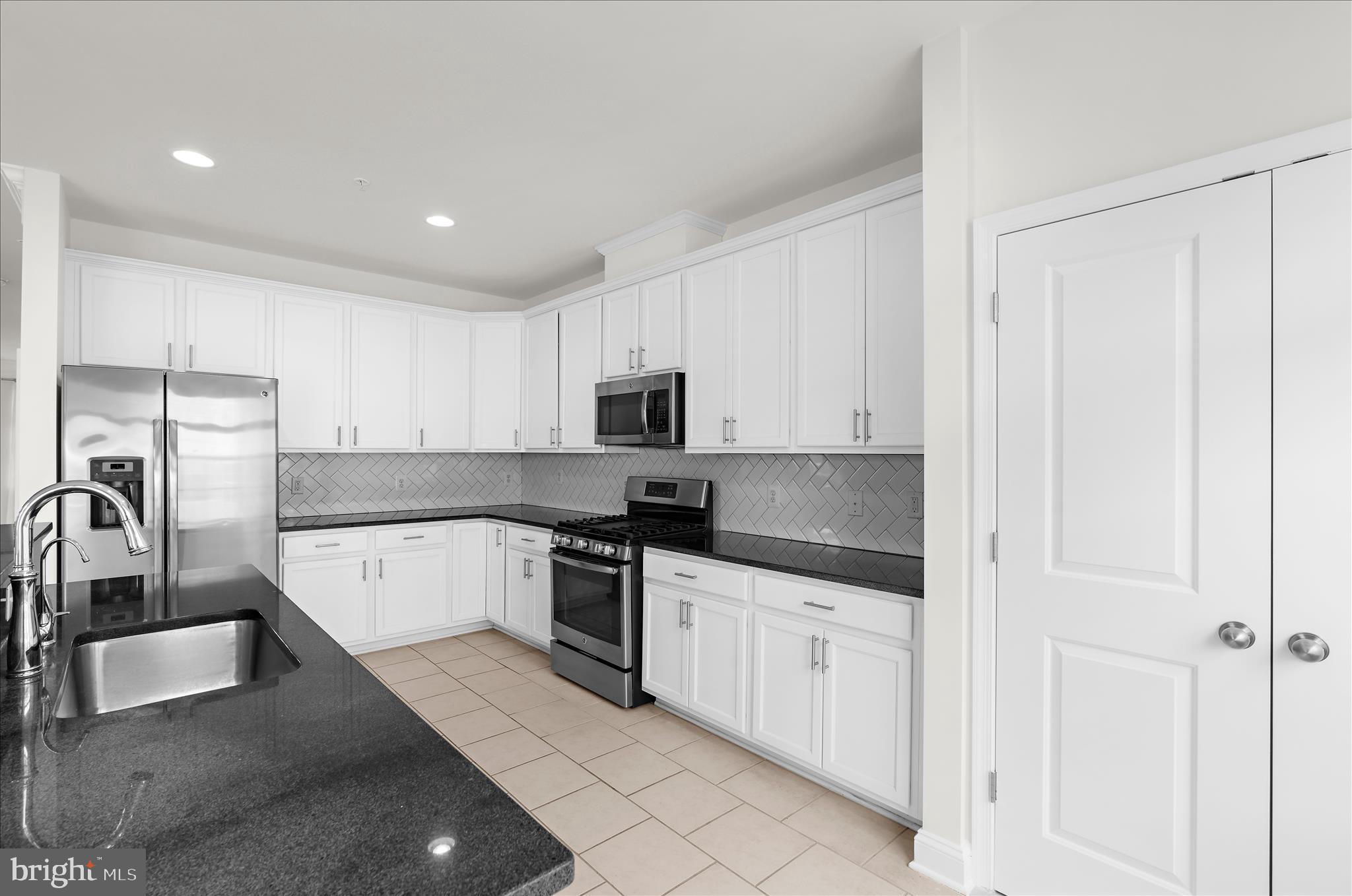 1704 Fieldstone Court Hanover, MD 21076 - Photo 16 of 47 a kitchen with white cabinets appliances and sink
