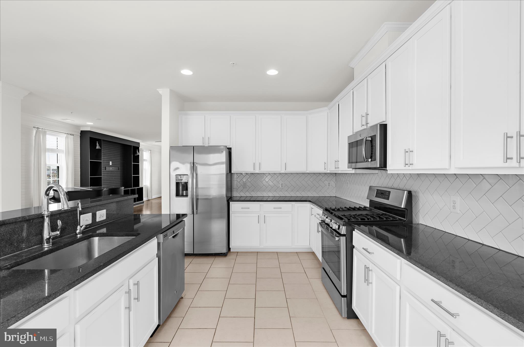 1704 Fieldstone Court Hanover, MD 21076 - Photo 18 of 47 a kitchen with a sink a stove and refrigerator