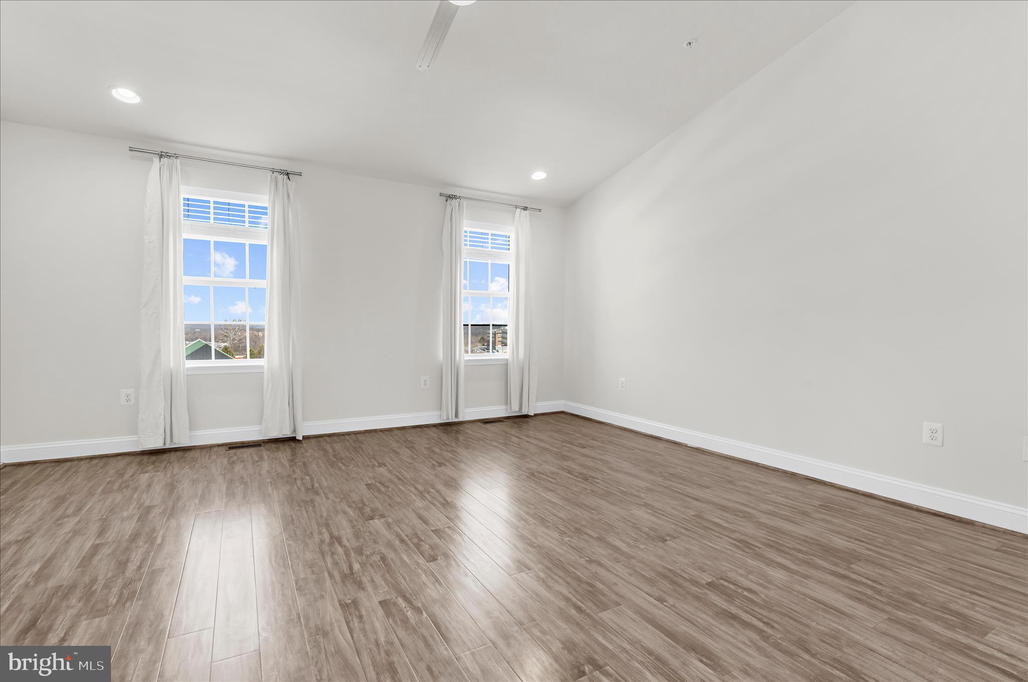 1704 Fieldstone Court Hanover, MD 21076 - Photo 21 of 47 a view of an empty room with wooden floor and a window