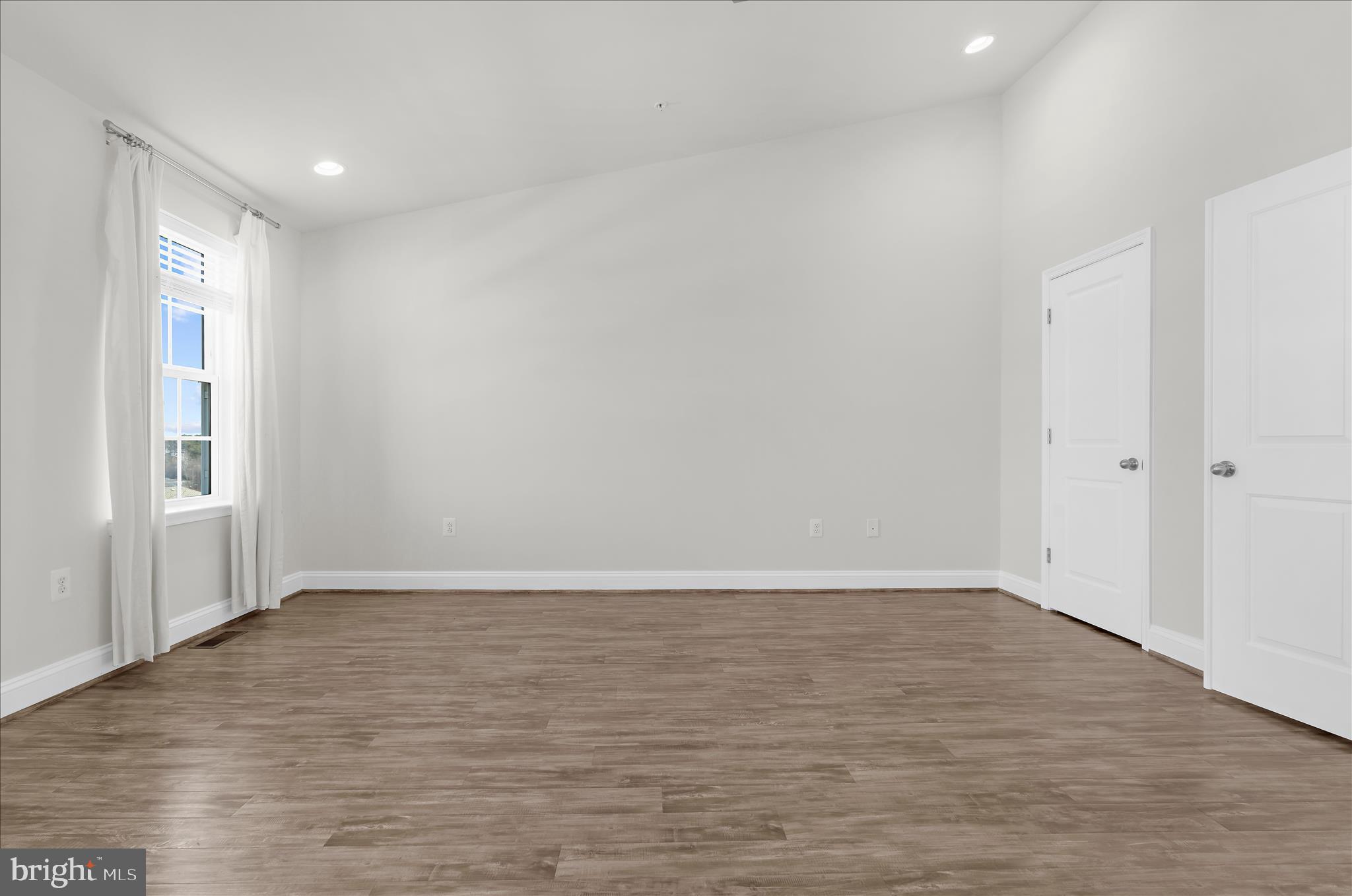 1704 Fieldstone Court Hanover, MD 21076 - Photo 23 of 47 a view of an empty room with wooden floor and a window