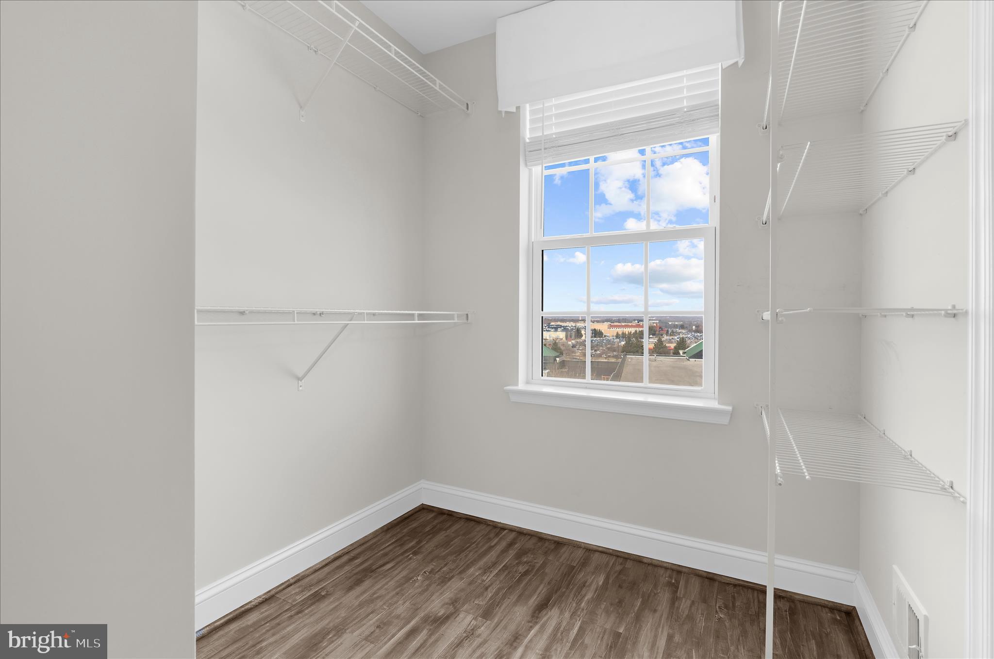 1704 Fieldstone Court Hanover, MD 21076 - Photo 24 of 47 a view of an empty room with wooden floor and a window