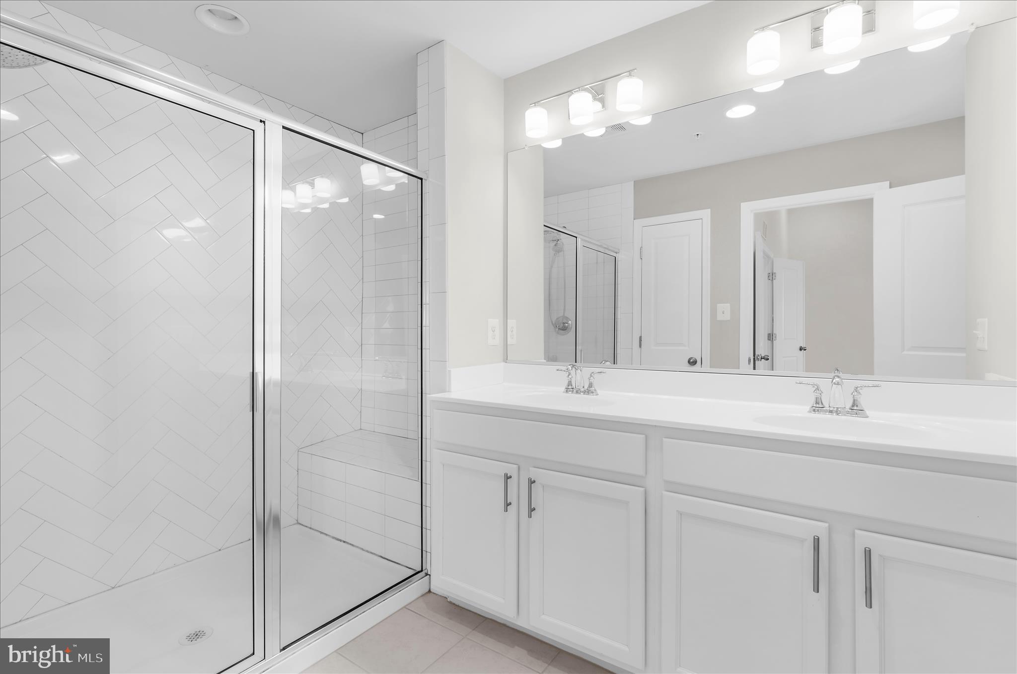 1704 Fieldstone Court Hanover, MD 21076 - Photo 27 of 47 a bathroom with a shower sink and mirror