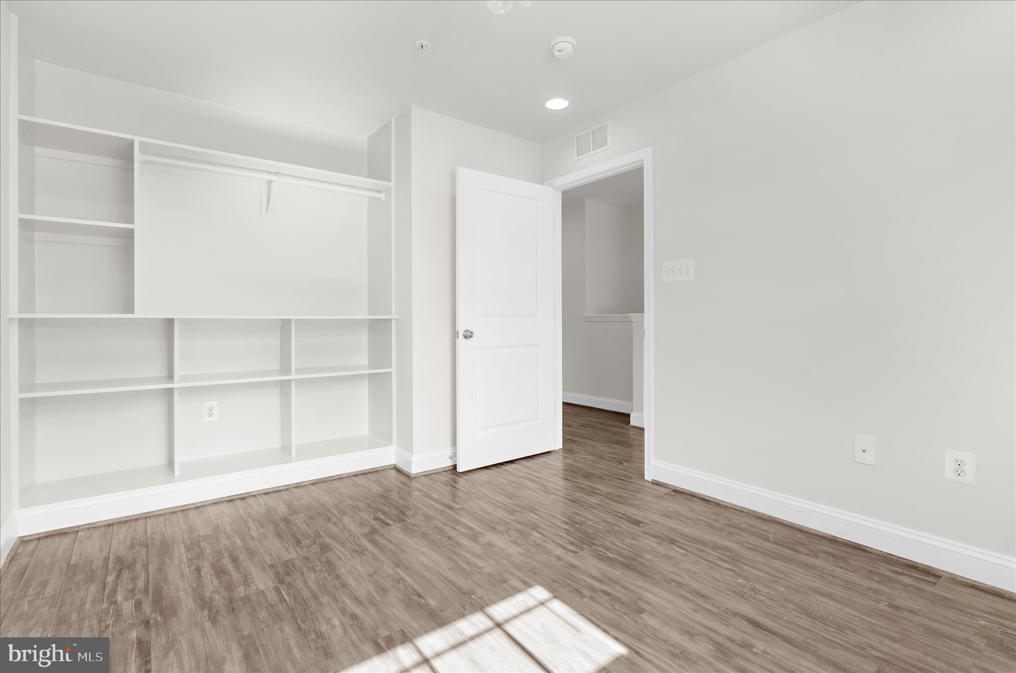 1704 Fieldstone Court Hanover, MD 21076 - Photo 32 of 47 a view of an empty room with wooden floor and closet