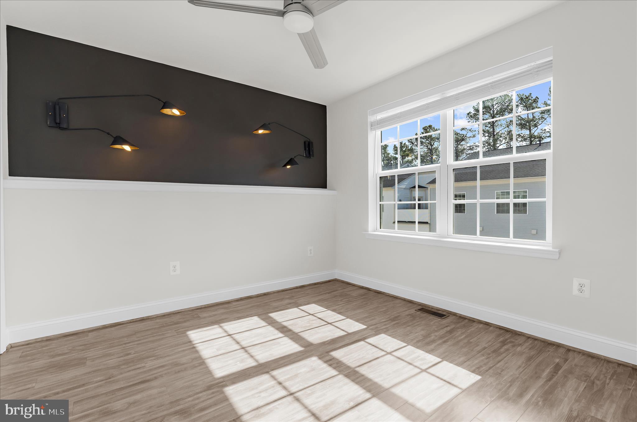 1704 Fieldstone Court Hanover, MD 21076 - Photo 34 of 47 a view of an empty room with wooden floor and windows