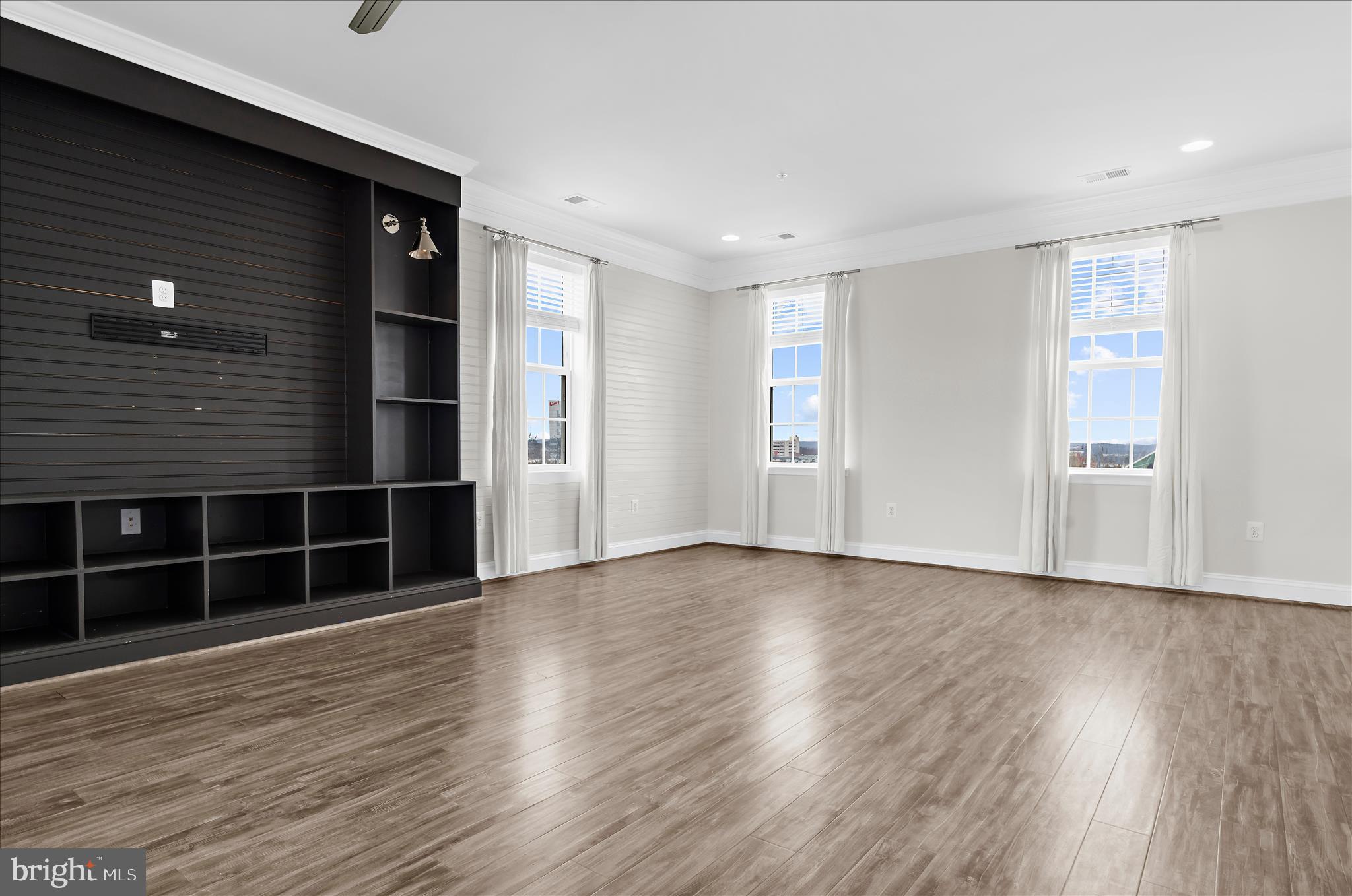 1704 Fieldstone Court Hanover, MD 21076 - Photo 9 of 47 a view of empty room with wooden floor and windows