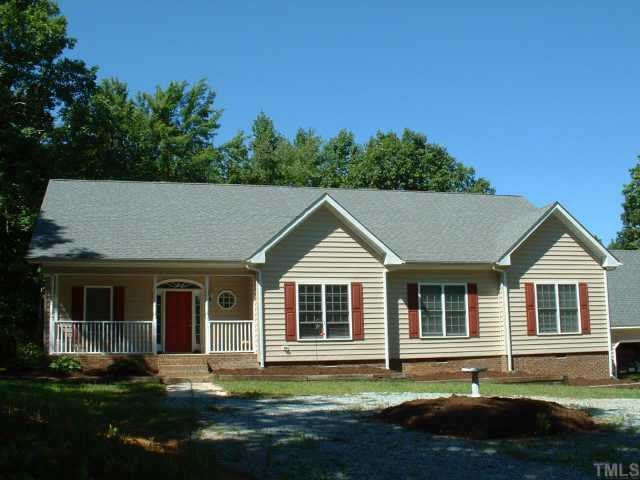 1236 Gillis Road Roxboro, NC 27574 - Photo 1 of 1 a front view of a house with a garden