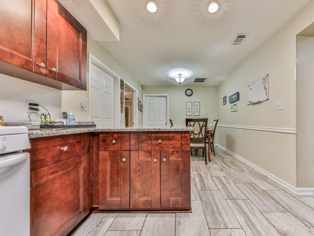 3605 Shallowford Road Marietta, GA 30062 - Photo 13 of 42 a kitchen with stainless steel appliances granite countertop a refrigerator and a stove top oven
