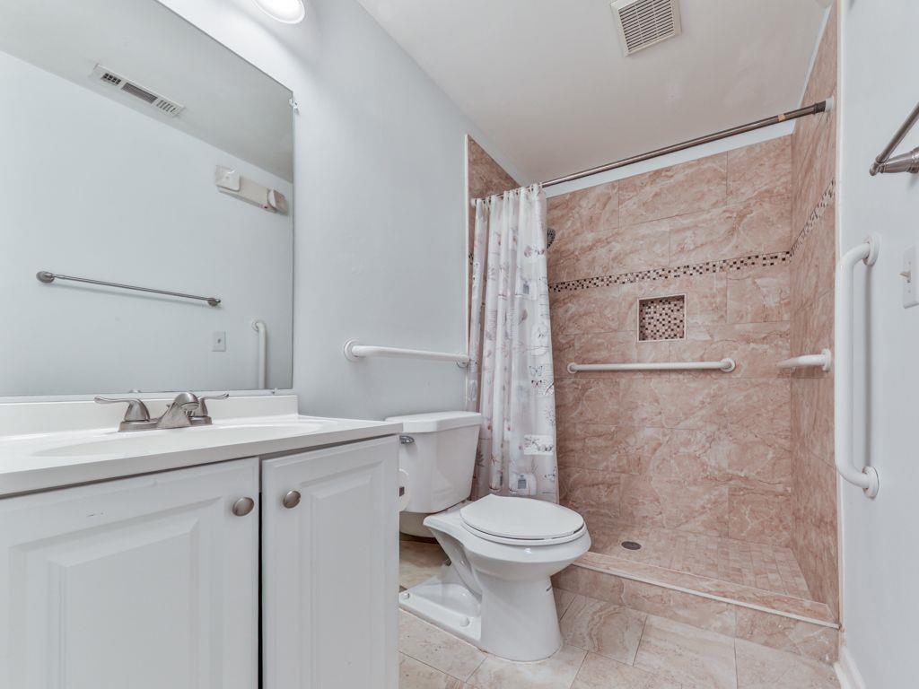 3605 Shallowford Road Marietta, GA 30062 - Photo 15 of 42 a white toilet sitting next to a bathroom sink