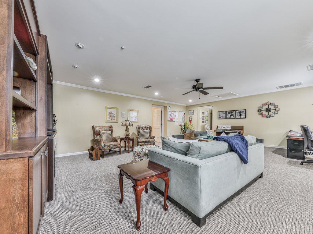 3605 Shallowford Road Marietta, GA 30062 - Photo 21 of 42 a living room with furniture and a chandelier