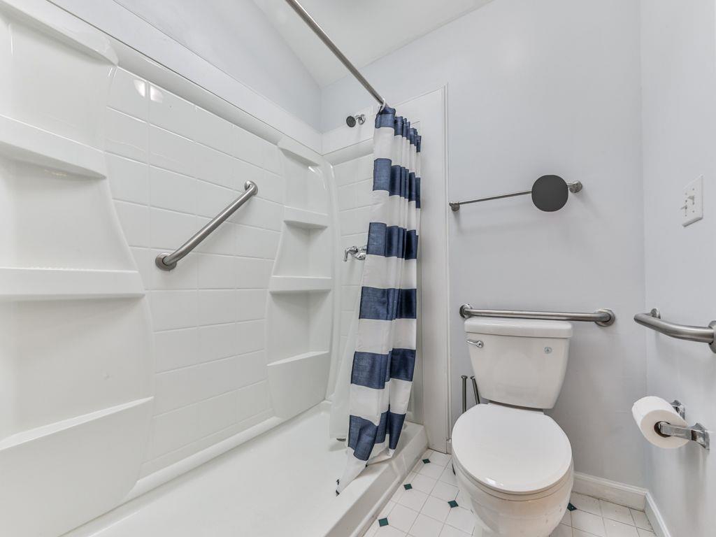 3605 Shallowford Road Marietta, GA 30062 - Photo 24 of 42 a bathroom with a toilet and a shower