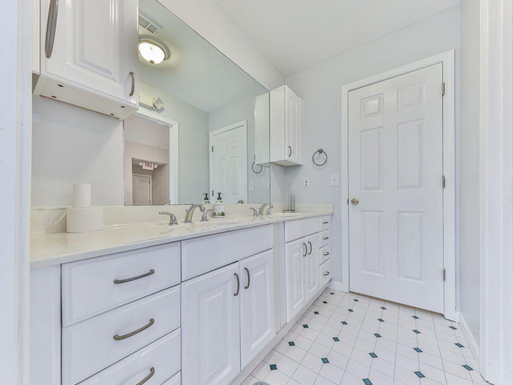 3605 Shallowford Road Marietta, GA 30062 - Photo 25 of 42 a bathroom with a granite countertop sink mirror and a shower