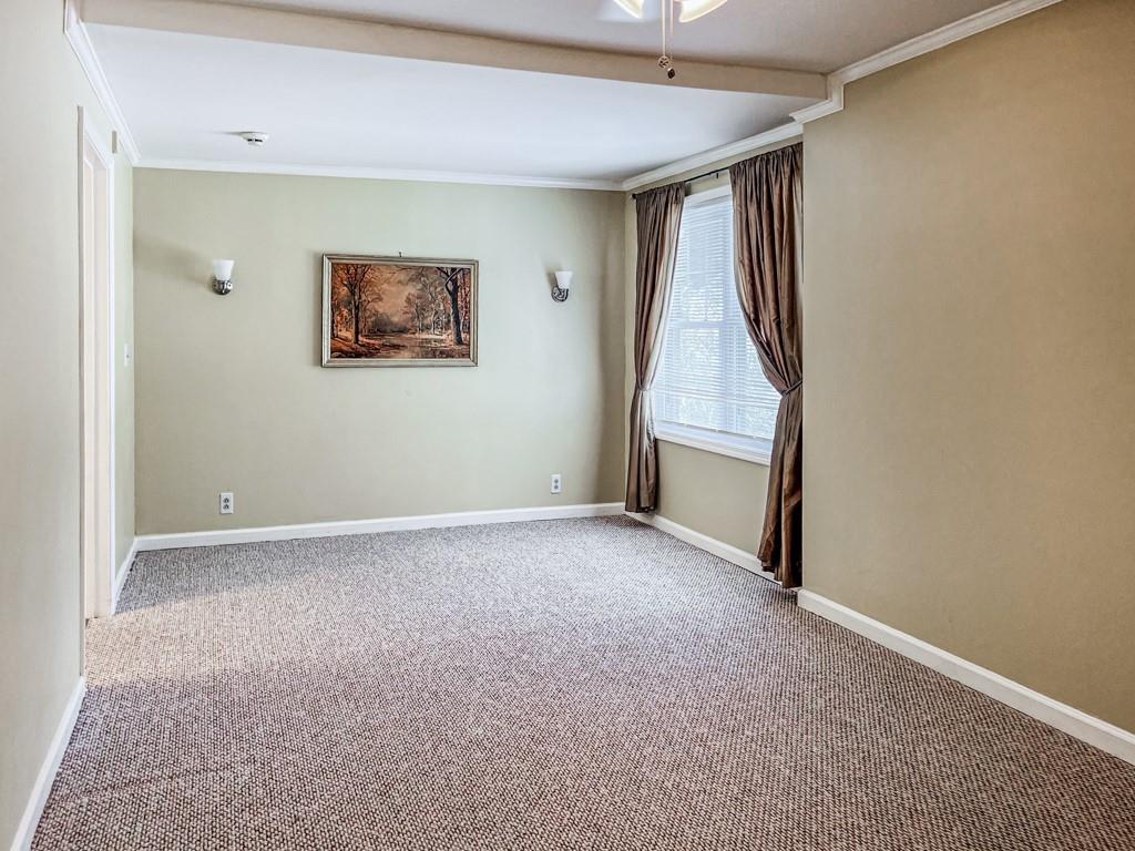 3605 Shallowford Road Marietta, GA 30062 - Photo 26 of 42 an empty room with a ceiling fan and window