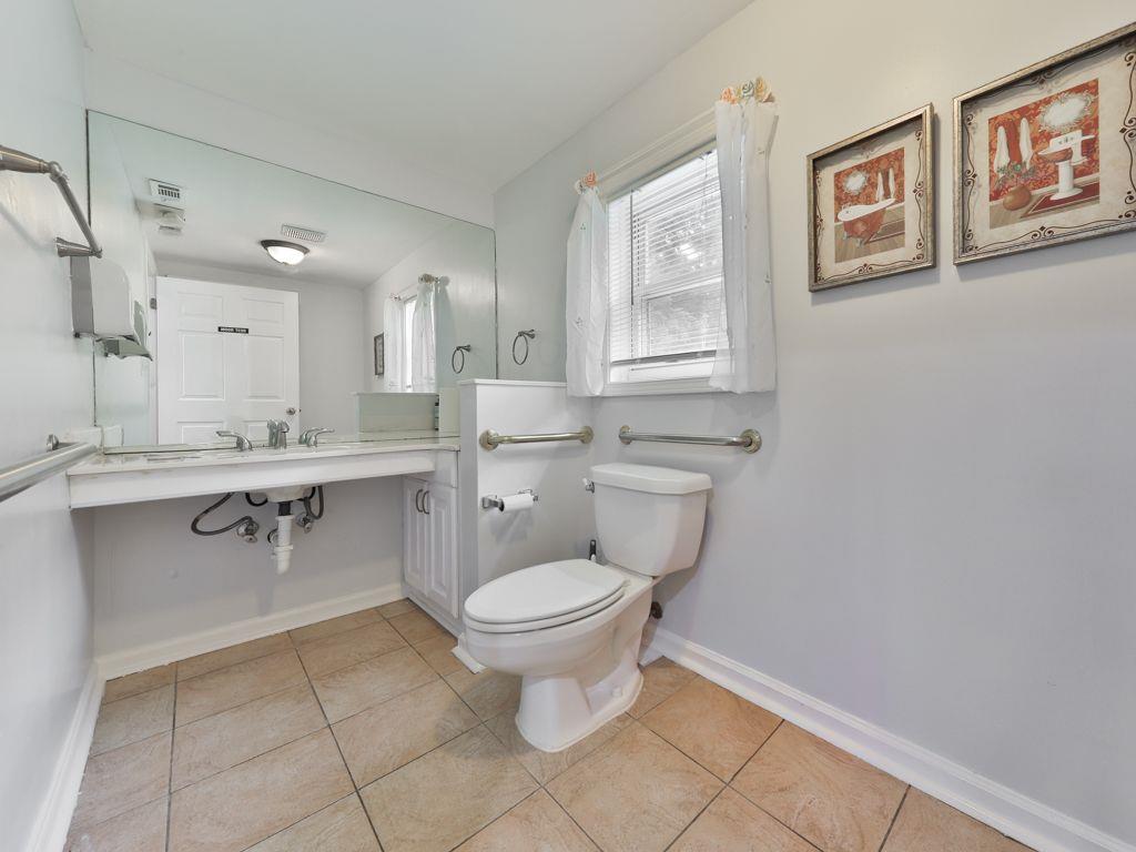 3605 Shallowford Road Marietta, GA 30062 - Photo 28 of 42 a bathroom with a toilet sink and mirror
