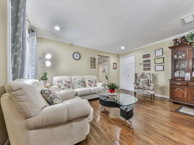 a living room with furniture a rug and a flat screen tv