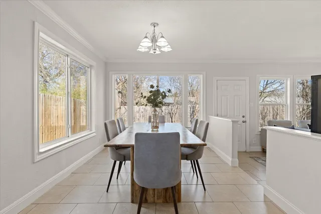 a kitchen with granite countertop sink table and chairs